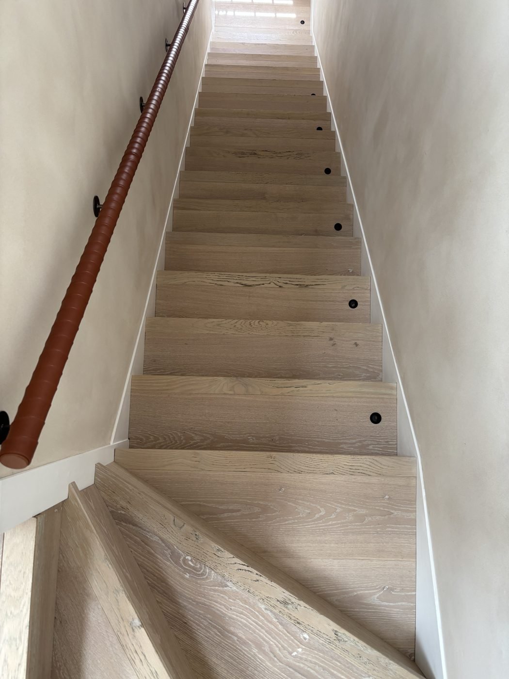 Oak staircase fitted with bullnose stair nosings and black non-slip stud inserts